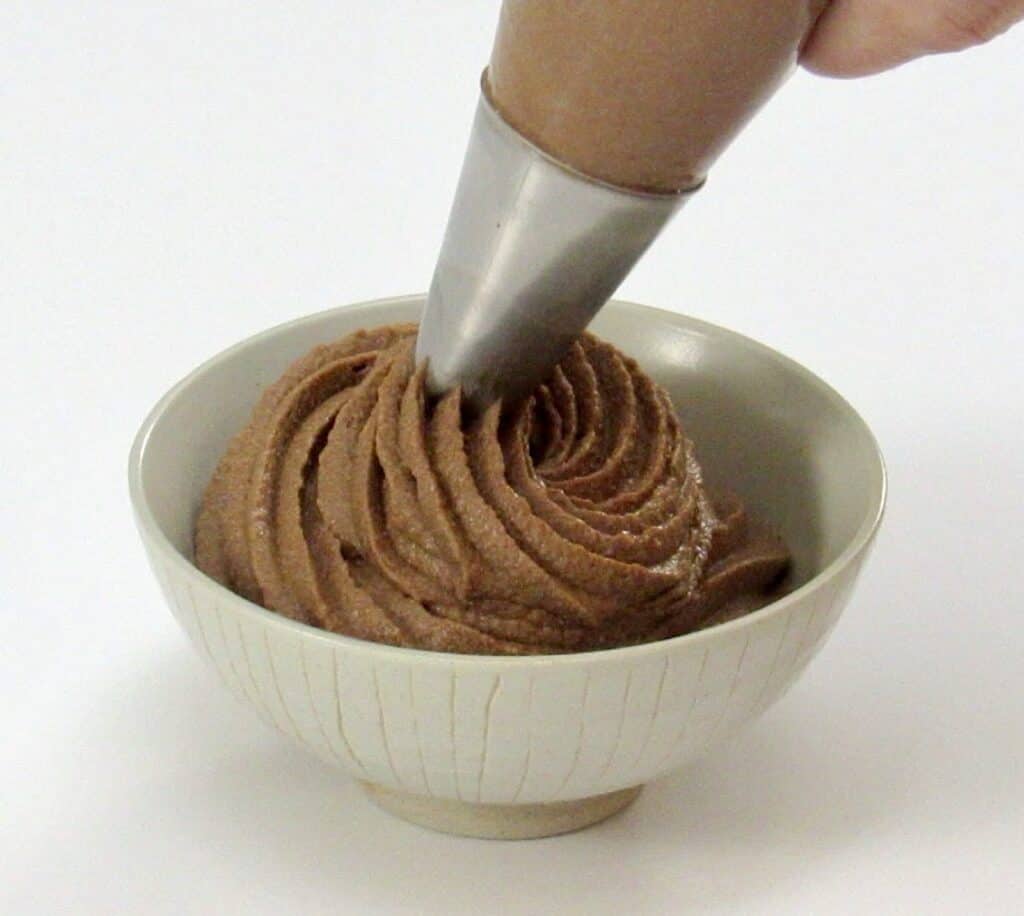 chocolate mousse being piped into a bowl