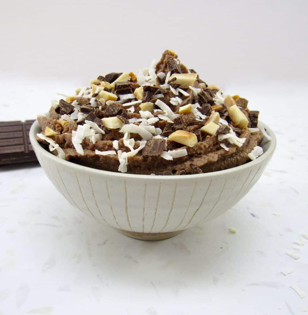 bowl of chocolate mousse with coconut and almonds