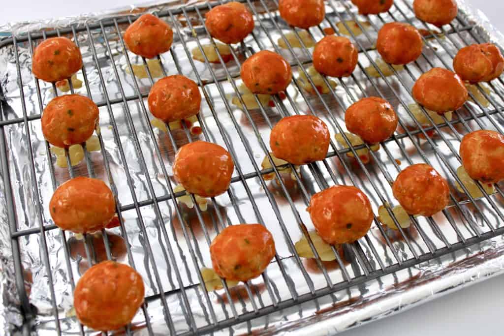 baked buffalo chicken meatballs on baking rack