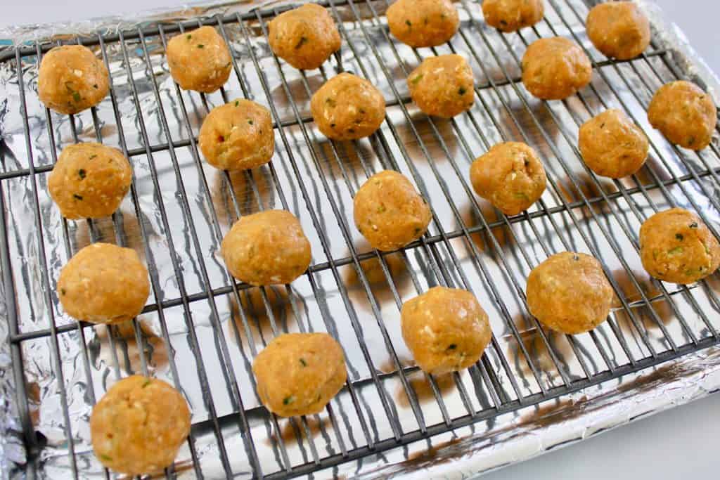 raw buffalo chicken meatballs on baking sheet