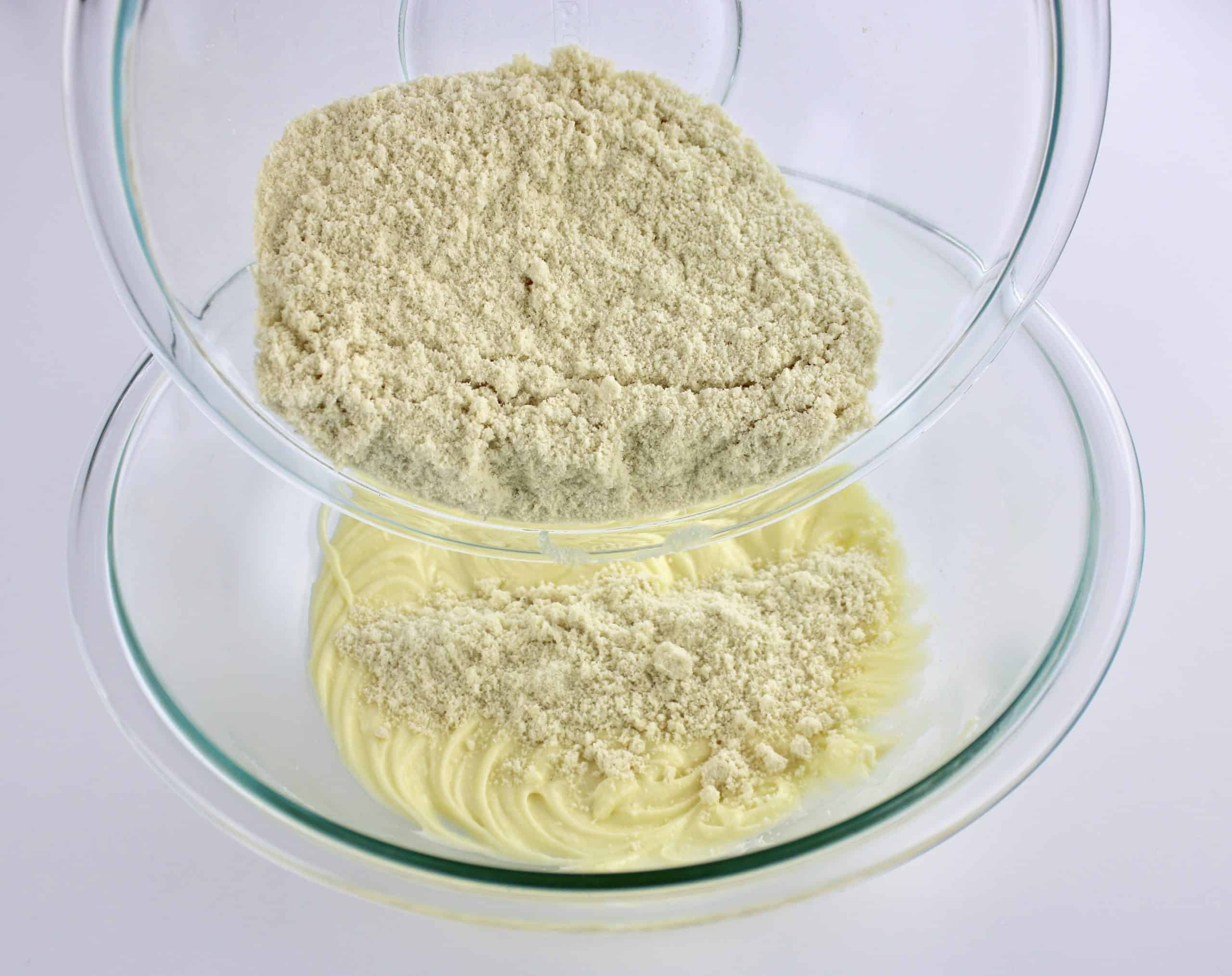 dry ingredients being poured into the wet ingredients for cookie dough