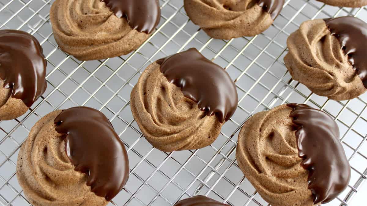 chocolate dipped Mocha Meringue Cookies on cooling rack